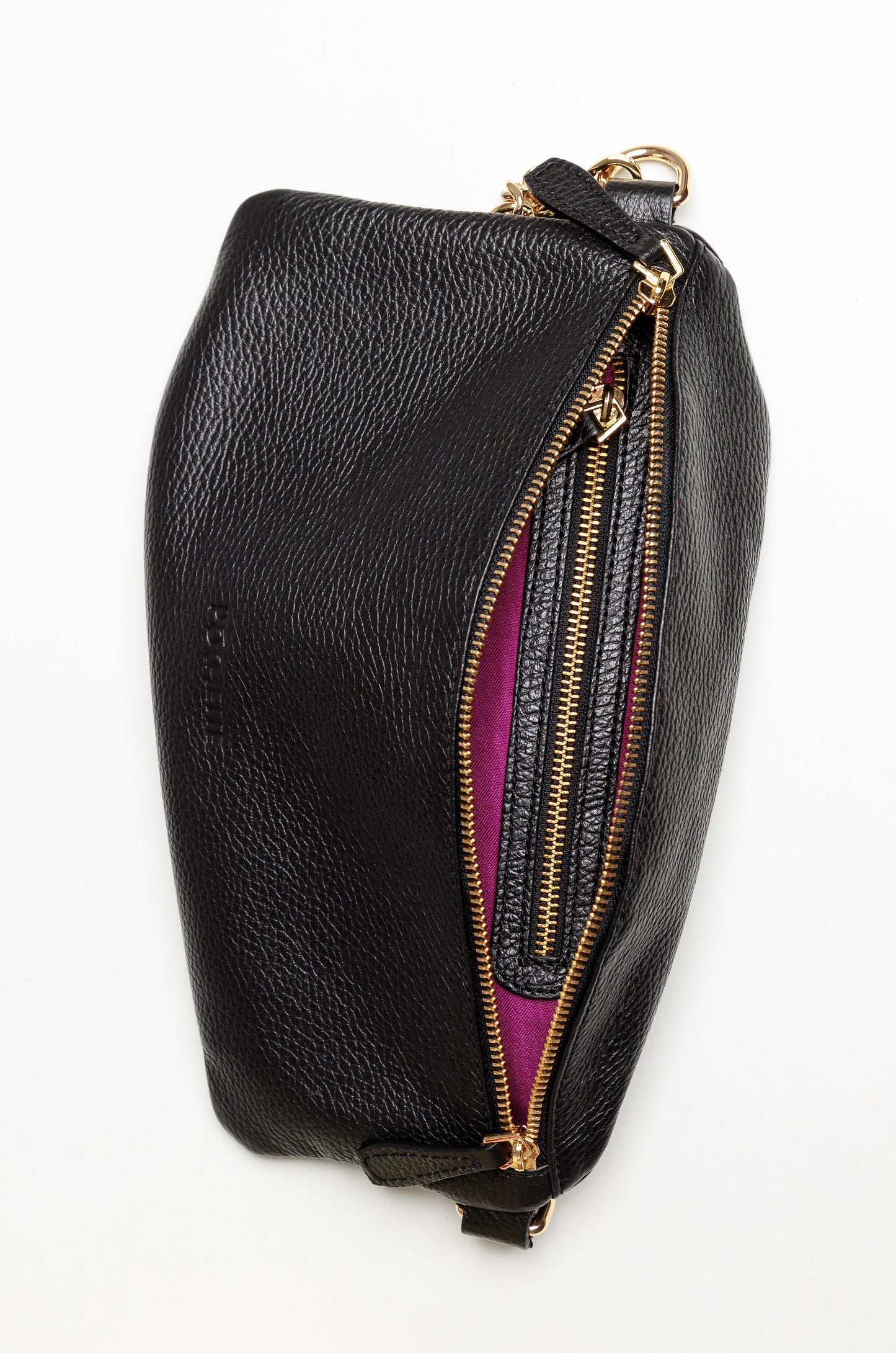The inside of a black Póca swing bag showing the brightly coloured syrah lining and an interior zipped pocket.