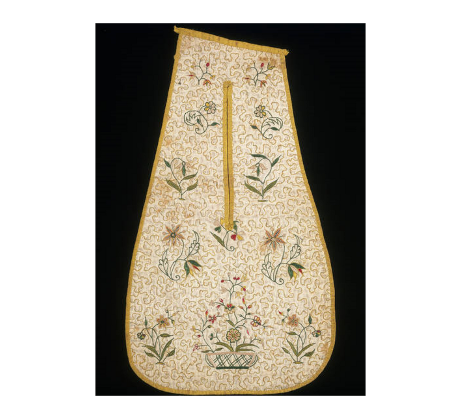 A seventeenth century embroidered pocket in mustard and cream with flowers on it.