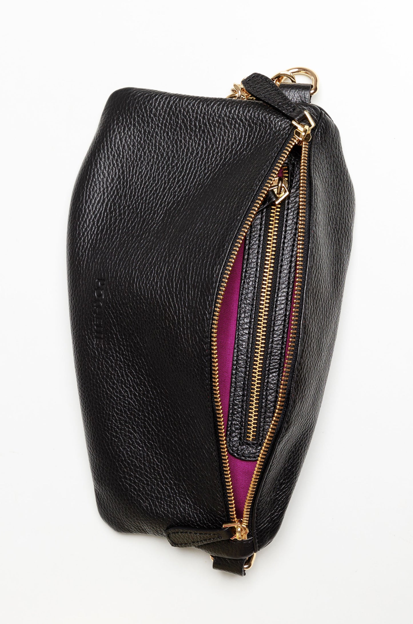 The inside of a black Póca swing bag showing the brightly coloured syrah lining and an interior zipped pocket. 