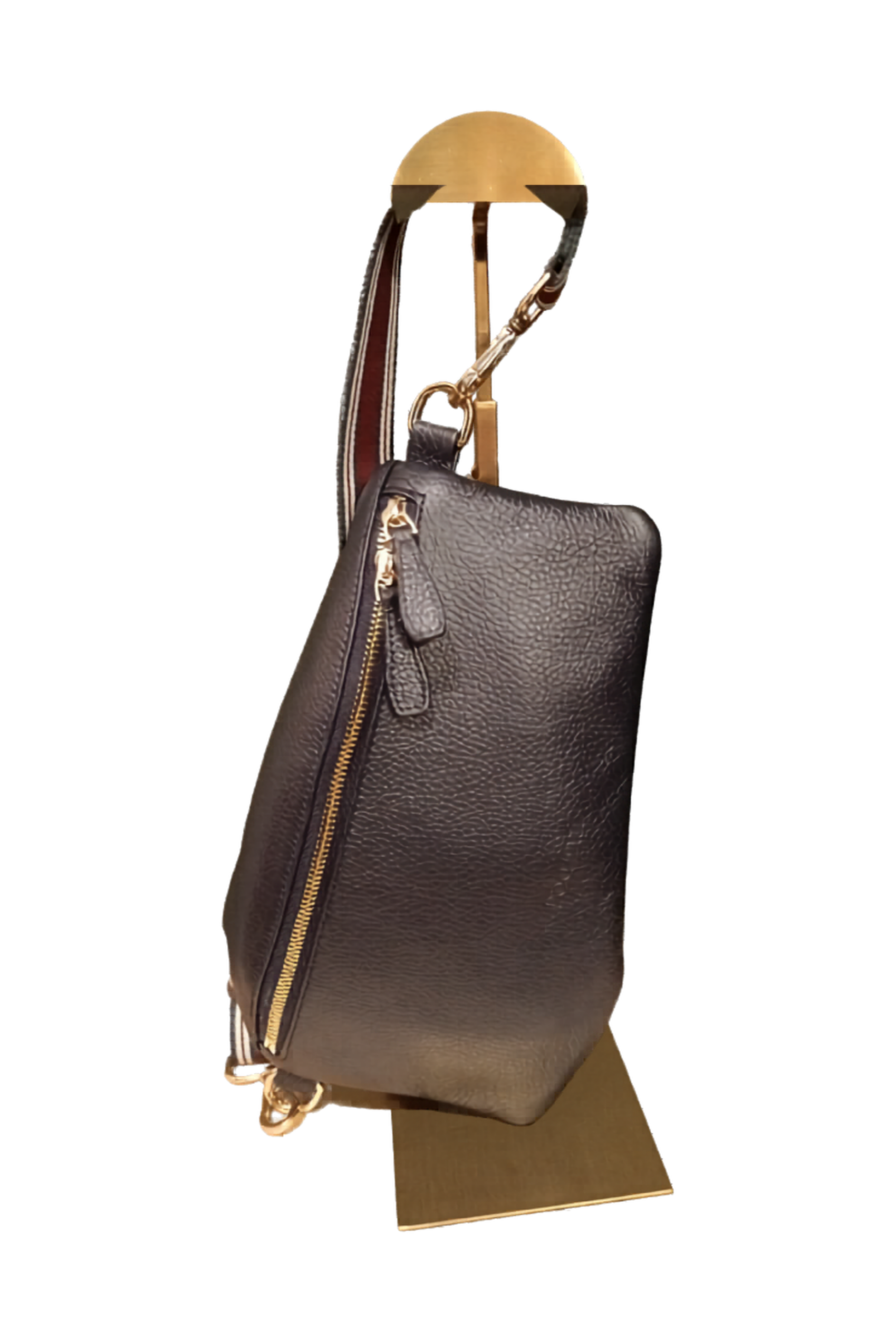Navy blue leather handbag with gold zipper and burgundy and navy striped strap on a white background