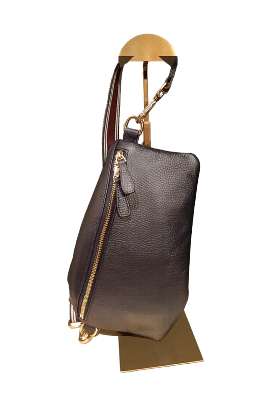 Navy blue leather handbag with gold zipper and burgundy and navy striped strap on a white background