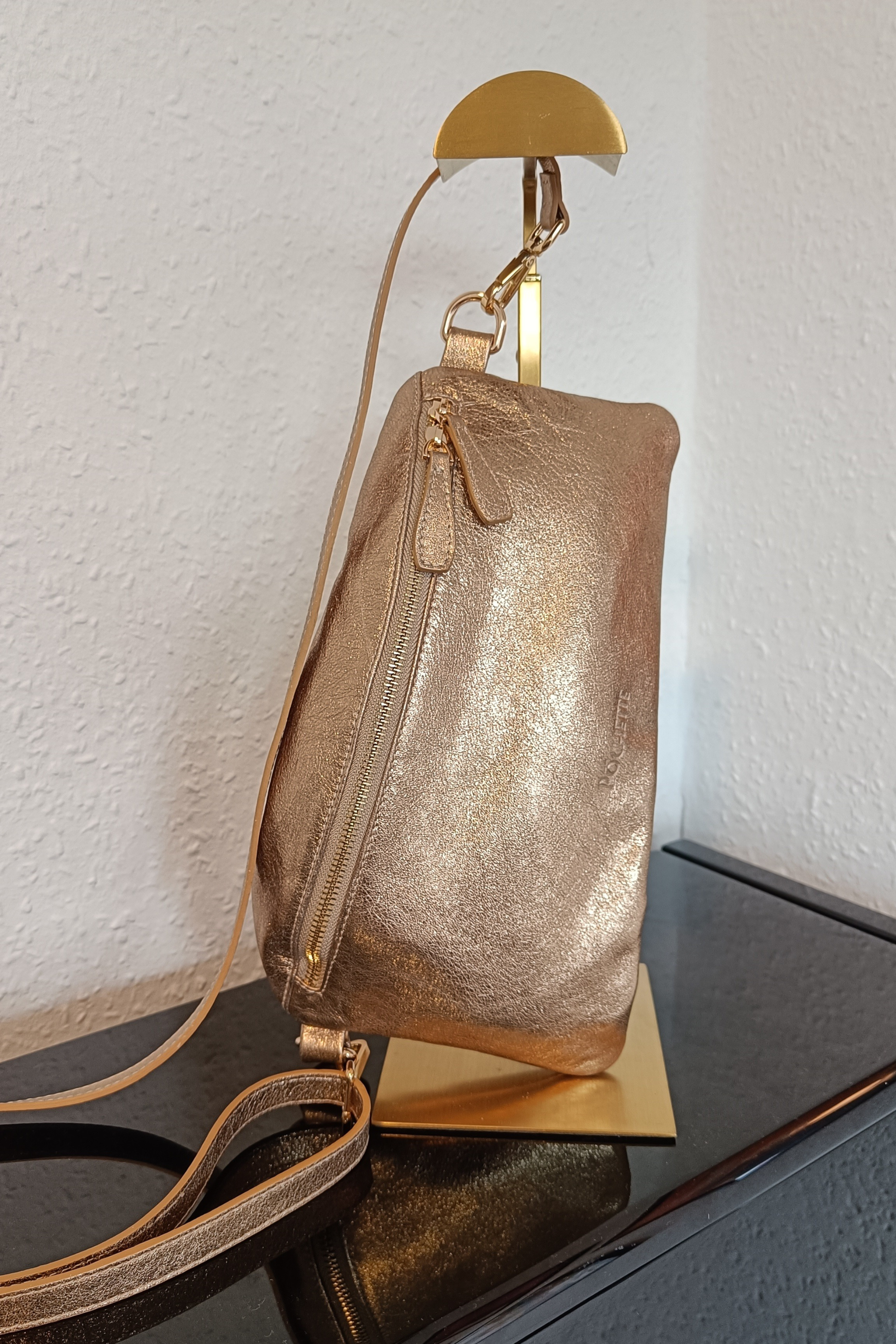 Póchette Statement Sparkle Póca handbag in Gold on a gold stand